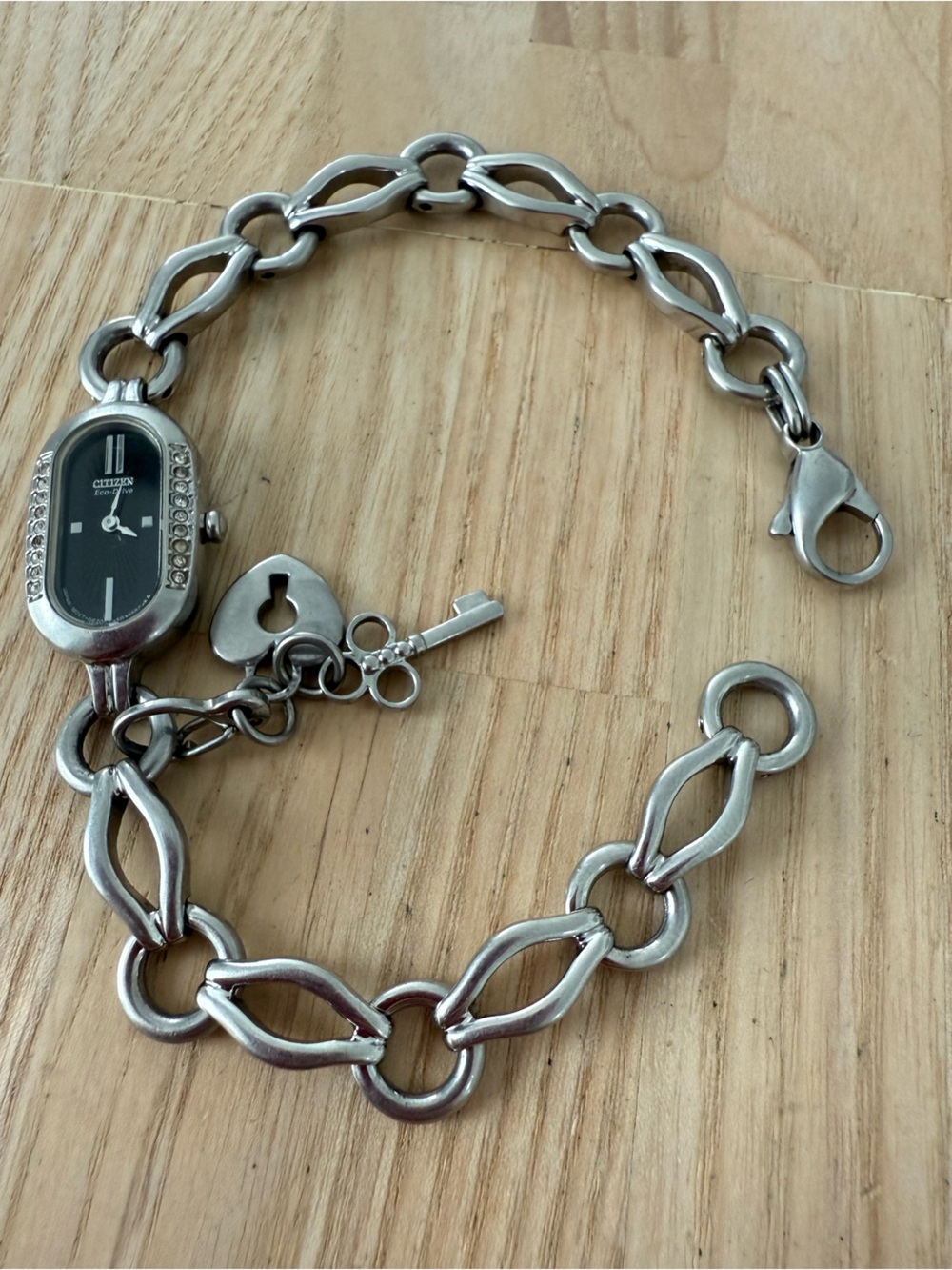 Citizen eco-drive ladies oval black dial silver tone chain bracelet solar watch